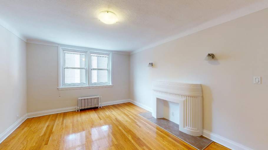 Bright and spacious living room with hardwood floors and fireplace
