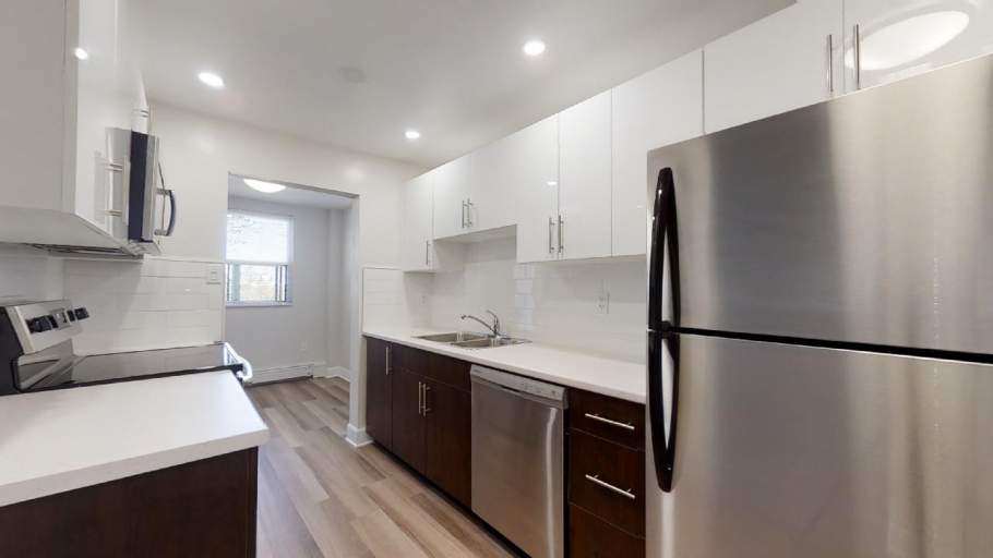 Renovated kitchen with stainless steel appliances, and dark brown and white cabinets