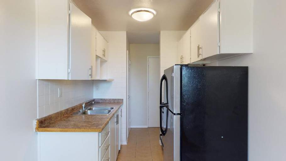 Renovated kitchen with stainless steel appliances and white cabinets