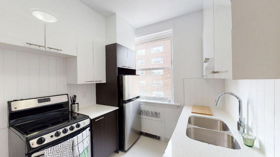 Renovated kitchen with stainless steel appliances and white cabinets