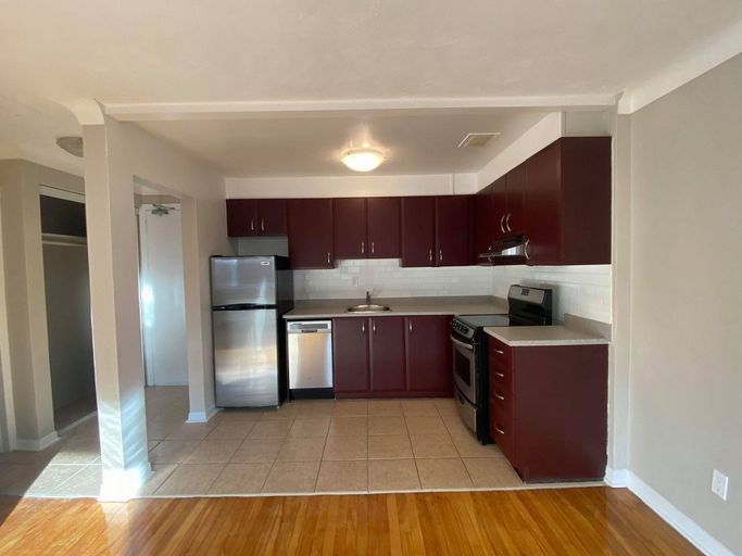 Renovated kitchen with stainless steel appliances, and dark brown cabinets