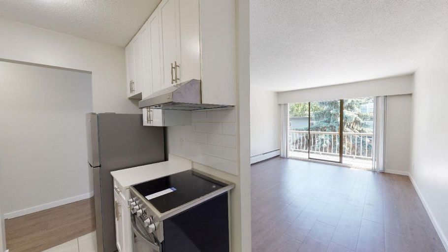 Renovated kitchen with stainless steel appliances and white cabinets